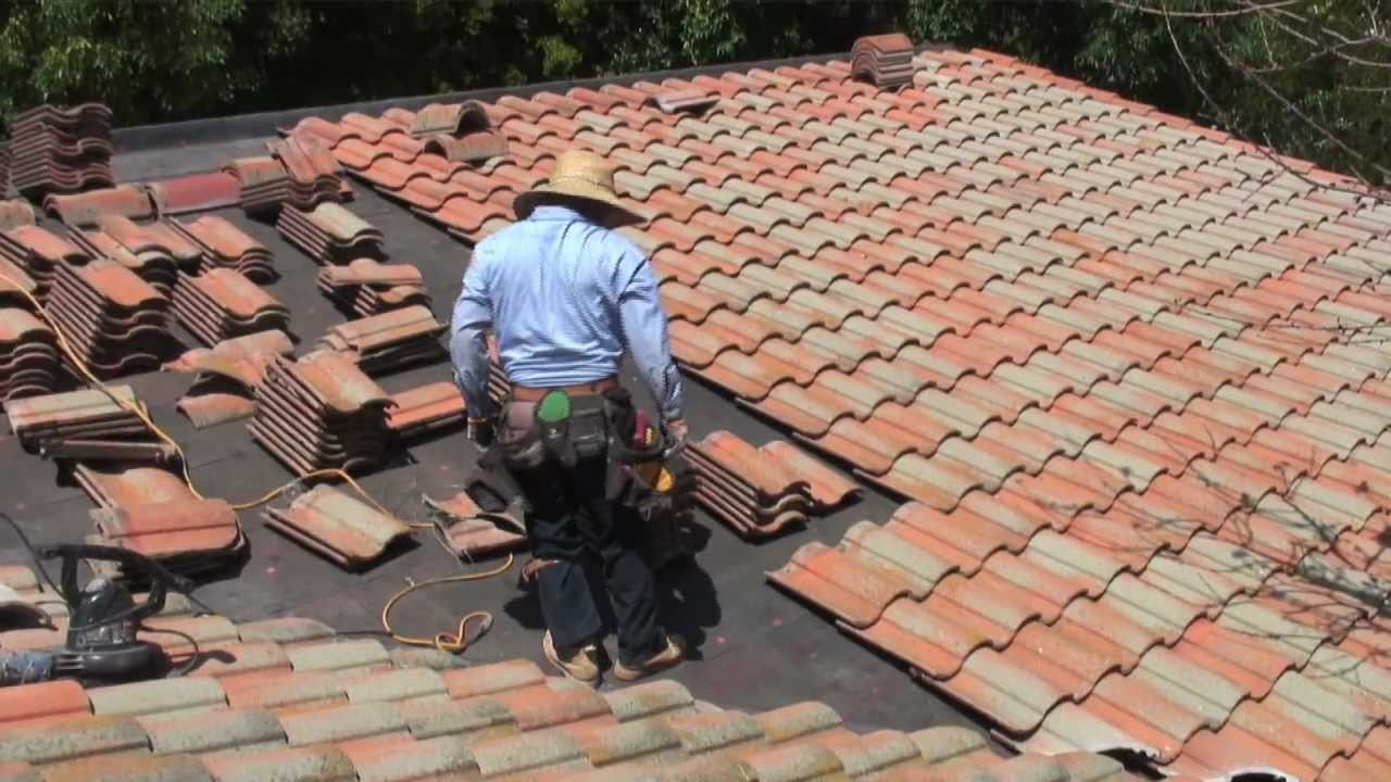 Roofer on a tiled roof residential home